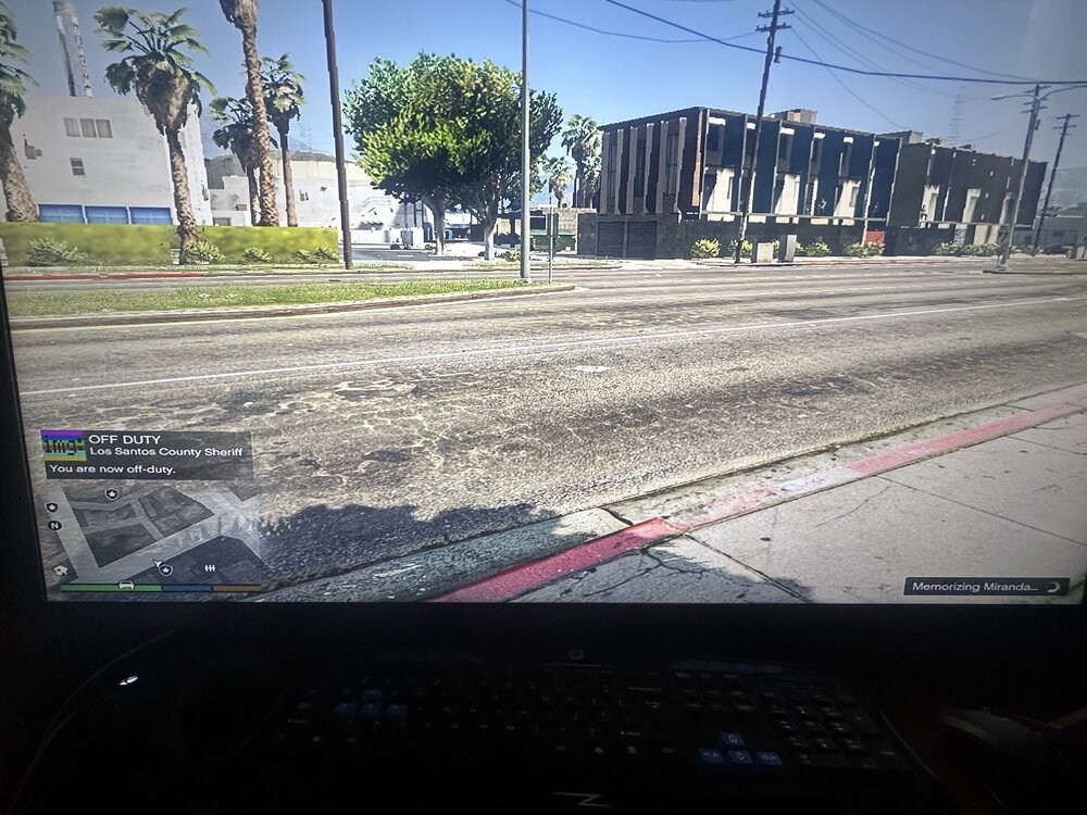 Could contain: outdoor, tree, sky, computer, text, billboard, screenshot, ground, street