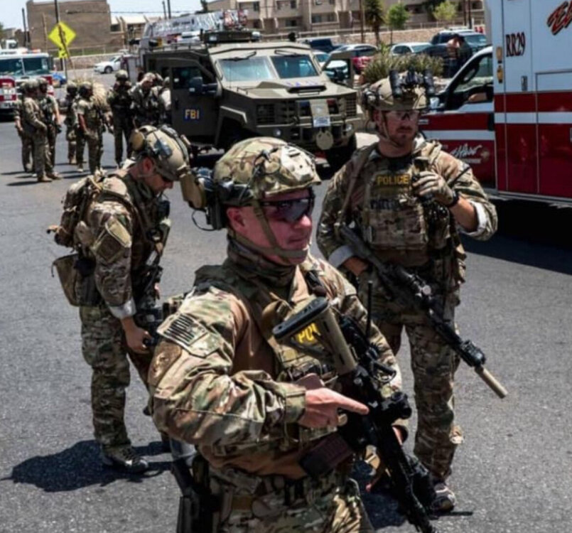 Could contain: outdoor, clothing, vehicle, land vehicle, military, military organization, soldier, military person, army, military camouflage, camouflage, infantry, person, marines, troop, military officer, law enforcement, security, organization, man, government agency, uniform, wheel, emergency service, military rank, squad, non-commissioned officer, helmet, road, rescuer, emergency, military uniform