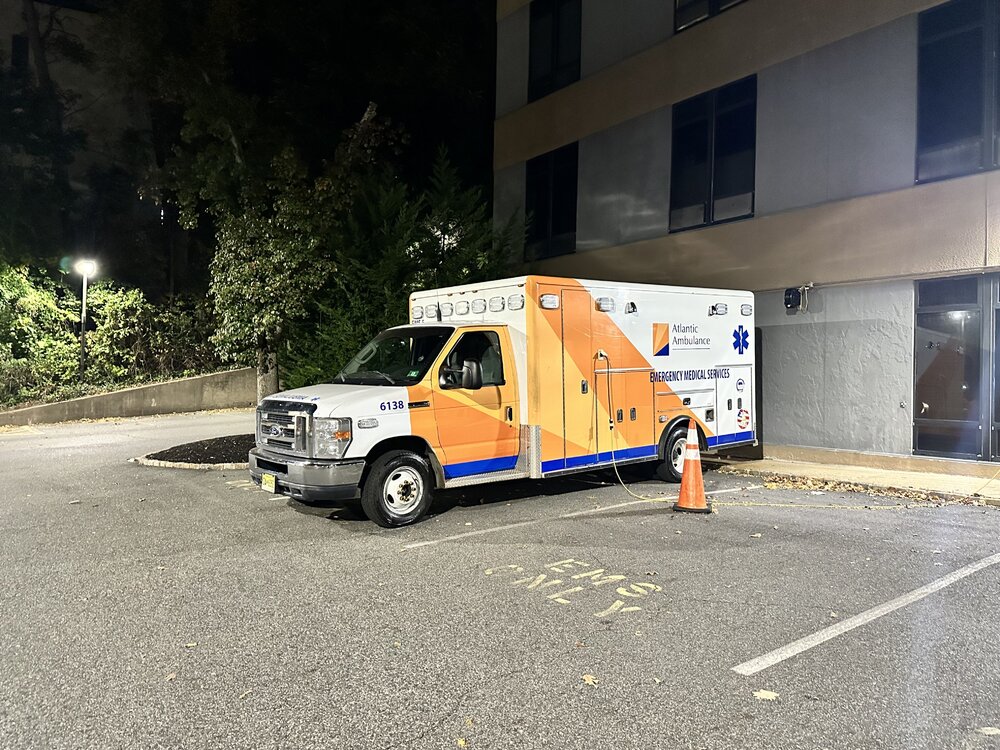 Could contain: vehicle, land vehicle, wheel, outdoor, transport, road, tire, building, light commercial vehicle, motor vehicle, auto part, van, car, road surface, mode of transport, ground, orange, street, truck