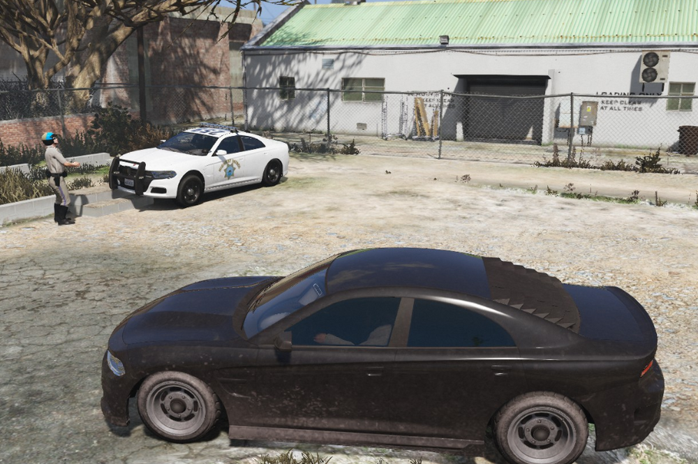 Could contain: wheel, vehicle, outdoor, land vehicle, ground, tire, auto part, building, parked, automotive design, vehicle door, transport, car, sitting