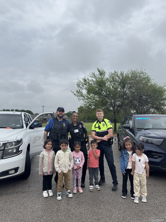 Could contain: sky, outdoor, land vehicle, vehicle, car, clothing, person, footwear, wheel, cloud, group, family car, people, tire, child, boy, ground, standing