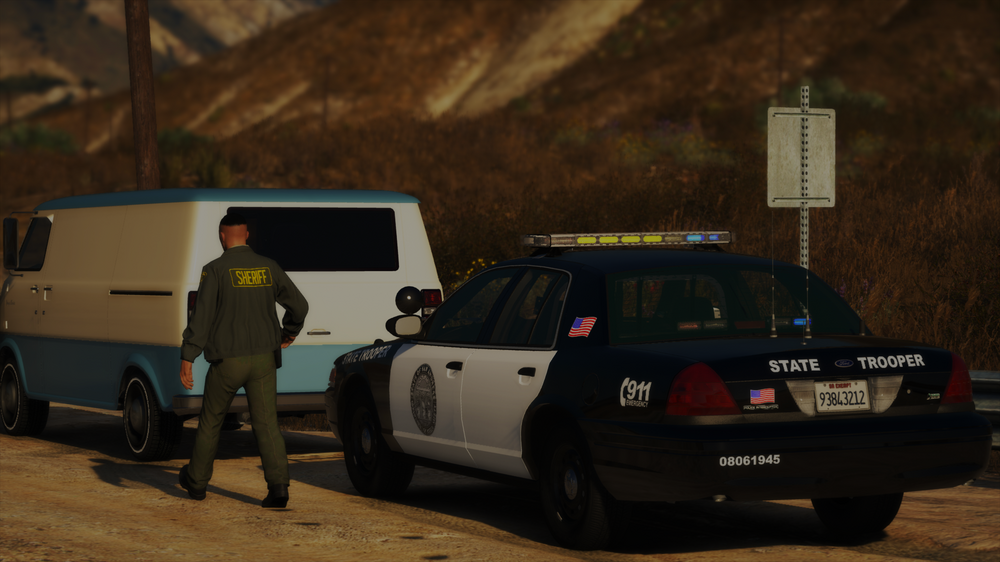 Could contain: vehicle, land vehicle, outdoor, wheel, tire, transport, vehicle registration plate, automotive exterior, automotive luggage rack, car, ground, van, police, person, mountain