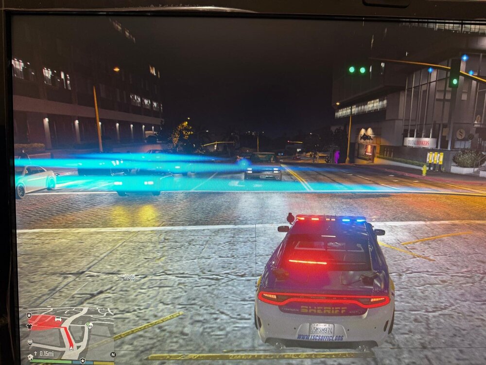 Could contain: vehicle, text, land vehicle, car, outdoor, building, automotive tail & brake light, automotive lighting, ground, street, light, road, city, night, red