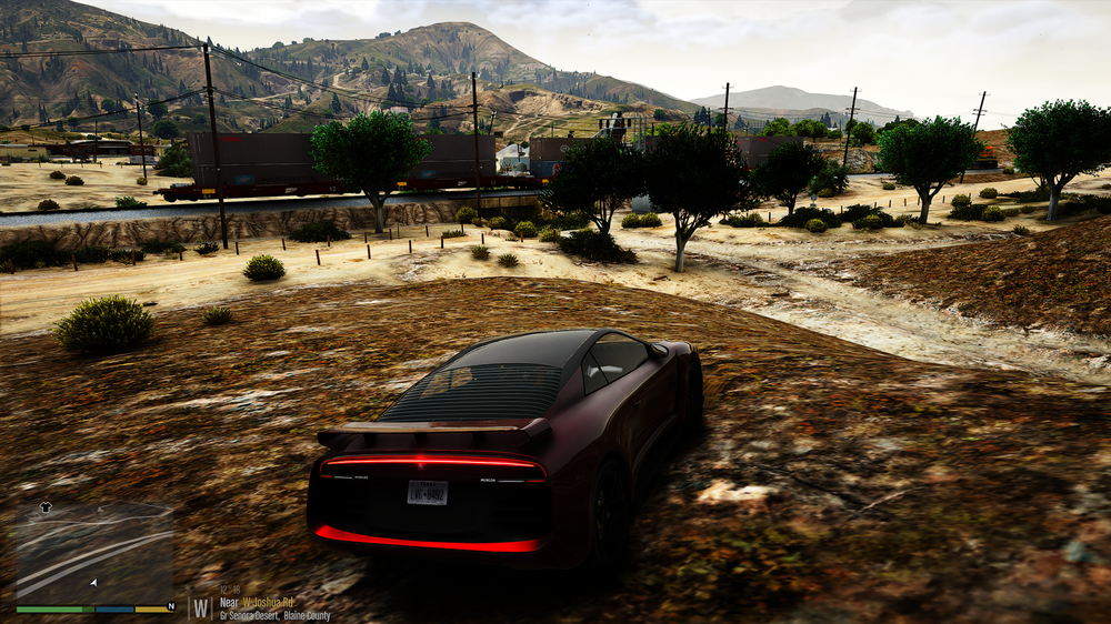 Could contain: outdoor, sky, ground, vehicle, mountain, land vehicle, tree, cloud, plant, car, grass, landscape, hill, rock, travel, track