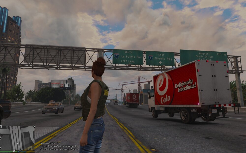 Could contain: outdoor, text, sky, cloud, road, land vehicle, clothing, billboard, truck, vehicle, wheel, person, man, advertising, street, sign, woman