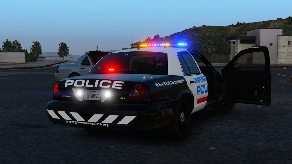 Could contain: vehicle, land vehicle, text, outdoor, transport, wheel, sky, police car, vehicle registration plate, law enforcement, tire, emergency service, emergency vehicle, full-size car, automotive exterior, auto part, road, police, automotive light bulb, ford crown victoria police interceptor, automotive tail & brake light, automotive lighting, bumper, emergency, ford, car, light