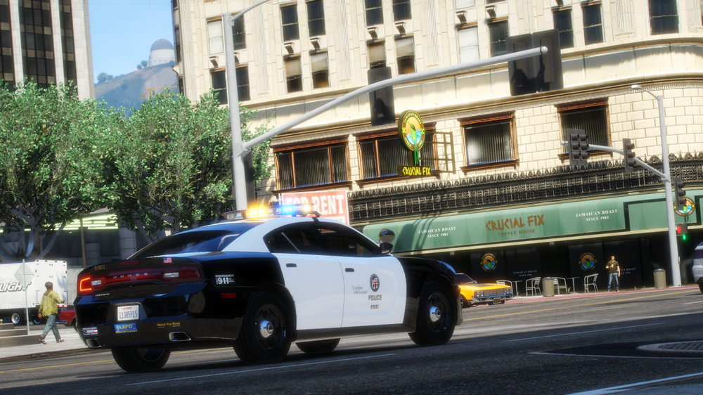 Could contain: vehicle, land vehicle, outdoor, building, wheel, road, street, transport, car, police, city