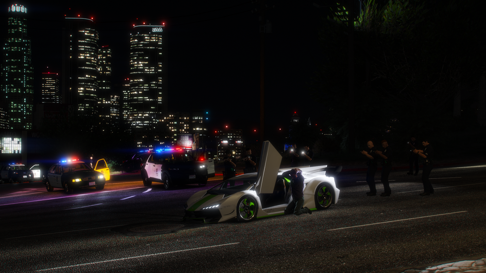 Could contain: outdoor, road, car, vehicle, land vehicle, night, street, skyscraper, wheel, city, light, people