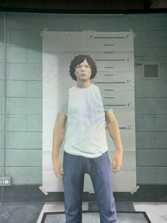 Could contain: clothing, person, footwear, trousers, denim, shoulder, building, human face, trouser, casual dress, wall, jeans, fashion, standing, shirt