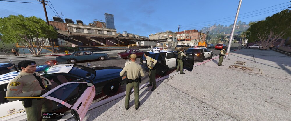 Could contain: outdoor, sky, ground, vehicle, land vehicle, car, tree, clothing, people, building, person, road, group, city, carriage, several, parked, street