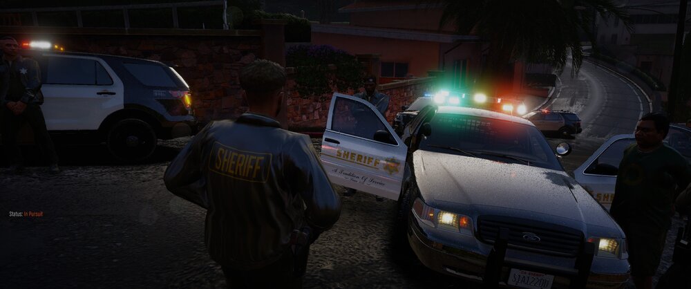 Could contain: vehicle, land vehicle, outdoor, transport, person, wheel, clothing, man, car, emergency service, auto part, road, police, street, night, people