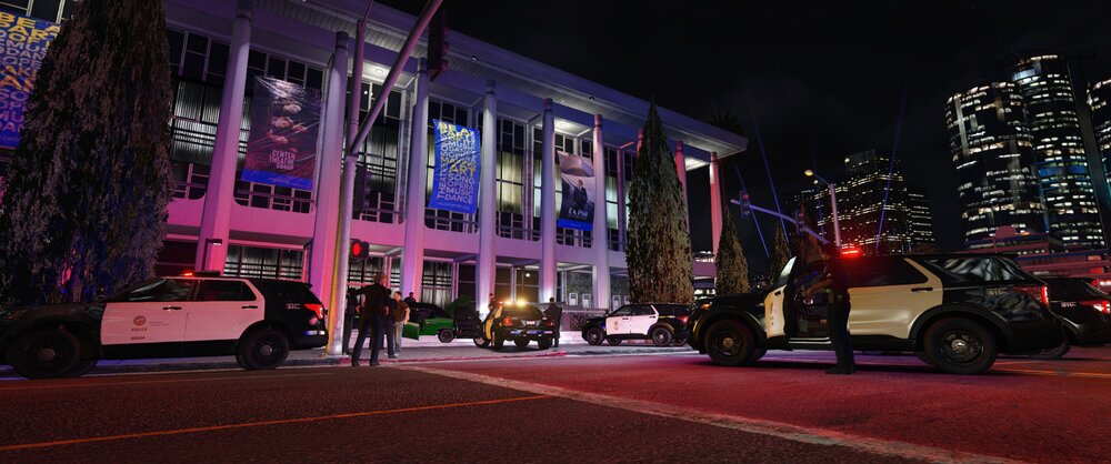 Could contain: building, outdoor, land vehicle, vehicle, wheel, car, road, night, sky, street, skyscraper, mixed-use, downtown, city, light, parked