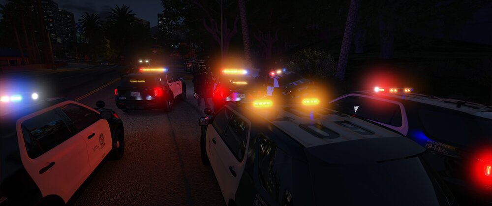 Could contain: outdoor, vehicle, land vehicle, car, light, road, night, street, ground, parked, ambulance, traffic