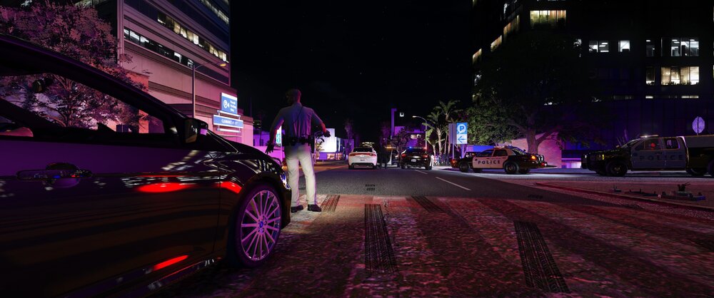 Could contain: outdoor, car, vehicle, land vehicle, building, road, purple, wheel, street, night, city, light, ground