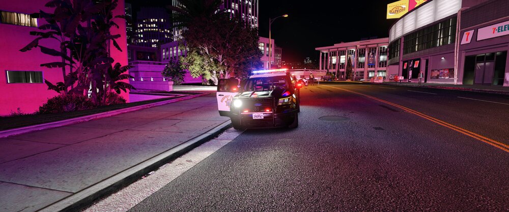 Could contain: outdoor, vehicle, land vehicle, car, road, building, road surface, light, city, way, night, ground, street