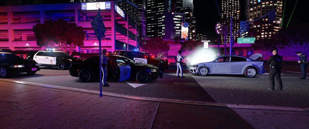 Could contain: vehicle, land vehicle, building, outdoor, wheel, night, skyscraper, car, road, street, city, ground, light