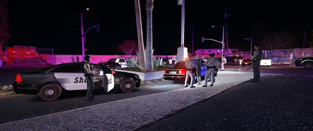 Could contain: outdoor, vehicle, land vehicle, car, road, wheel, street, street light, tire, light, night, people, ground, person, city, parked