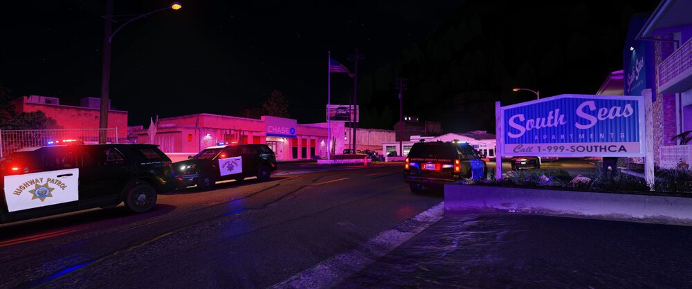 Could contain: outdoor, sky, building, vehicle, night, street, road, land vehicle, street light, electricity, billboard, light, sign, truck, parked
