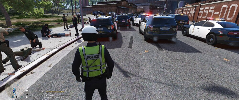 Could contain: outdoor, land vehicle, car, vehicle, clothing, text, wheel, road, person, tree, vehicle registration plate, footwear, street, pedestrian, police