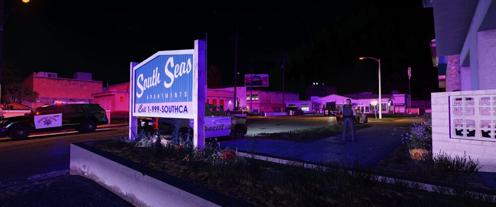 Could contain: outdoor, billboard, building, sign, night, sky, text, street, light