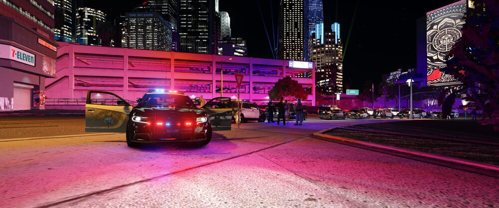 Could contain: building, vehicle, land vehicle, car, outdoor, road, skyscraper, city, street, night, wheel, light, ground, red