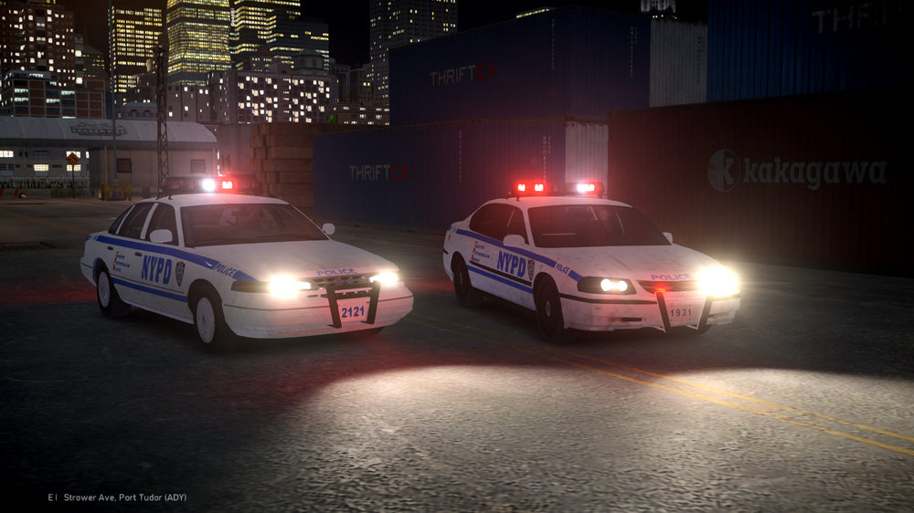 Could contain: vehicle, land vehicle, wheel, road, building, text, transport, outdoor, police car, full-size car, light, car, street, police, night, city