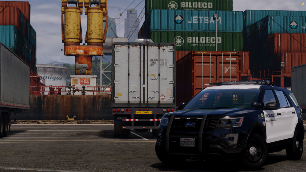 Could contain: vehicle, land vehicle, text, outdoor, wheel, tire, building, vehicle registration plate, road, street, container, police, car