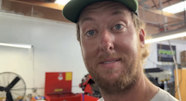 Could contain: human face, person, human beard, man, indoor, smile, wall, facial hair, clothing, hat, wearing