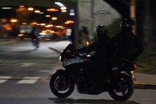 Could contain: land vehicle, vehicle, wheel, tire, outdoor, road, street, auto part, motorbike, text, motorcycling, automotive lighting, motorcycle fairing, motorcycle helmet, mode of transport, bike, night, motorcycle, city, person, light, police