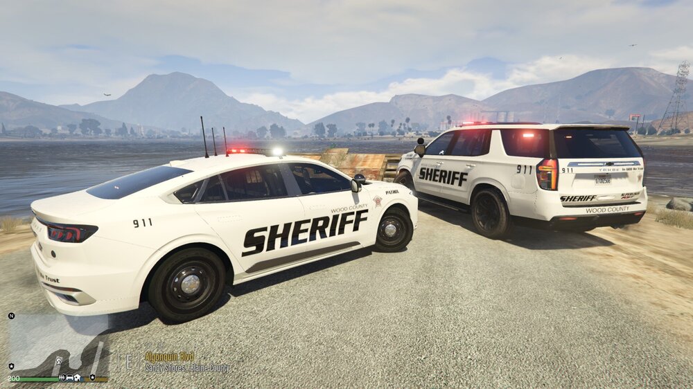 Could contain: vehicle, land vehicle, wheel, outdoor, transport, sky, tire, text, car, mountain, police car, auto part, vehicle registration plate, bumper, sport utility vehicle, ford, police, full-size car, motor vehicle, automotive exterior, compact sport utility vehicle, family car, crossover suv, ground, road, parked