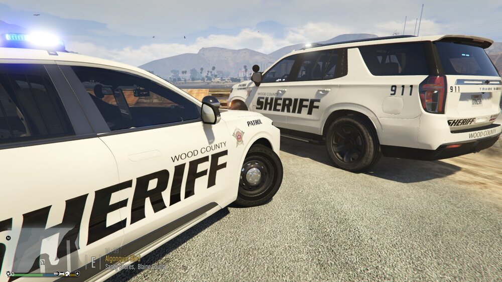 Could contain: vehicle, land vehicle, wheel, outdoor, text, sky, transport, tire, auto part, automotive exterior, car, police car, sport utility vehicle, motor vehicle, law enforcement, roof rack, vehicle registration plate, minivan, automotive luggage rack, road, van, parked, police, mountain, ground