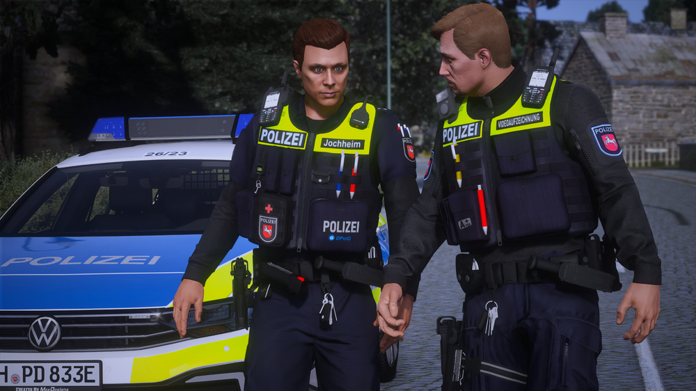 Could contain: clothing, person, outdoor, vehicle, land vehicle, car, law enforcement, text, emergency service, man, high-visibility clothing, police officer, emergency, police, officer