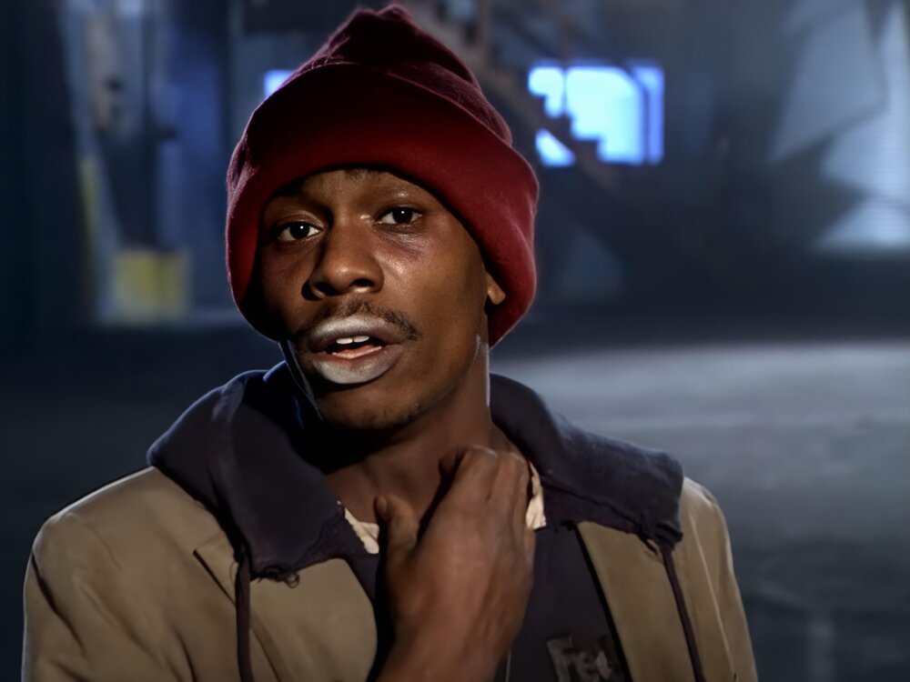 Could contain: human face, person, clothing, man, human, smile, fashion accessory, screenshot, street, portrait, hat, wearing