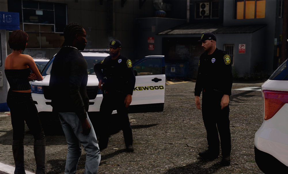 Could contain: vehicle, clothing, man, land vehicle, car, outdoor, person, footwear, building, ground, wheel, people, police, standing