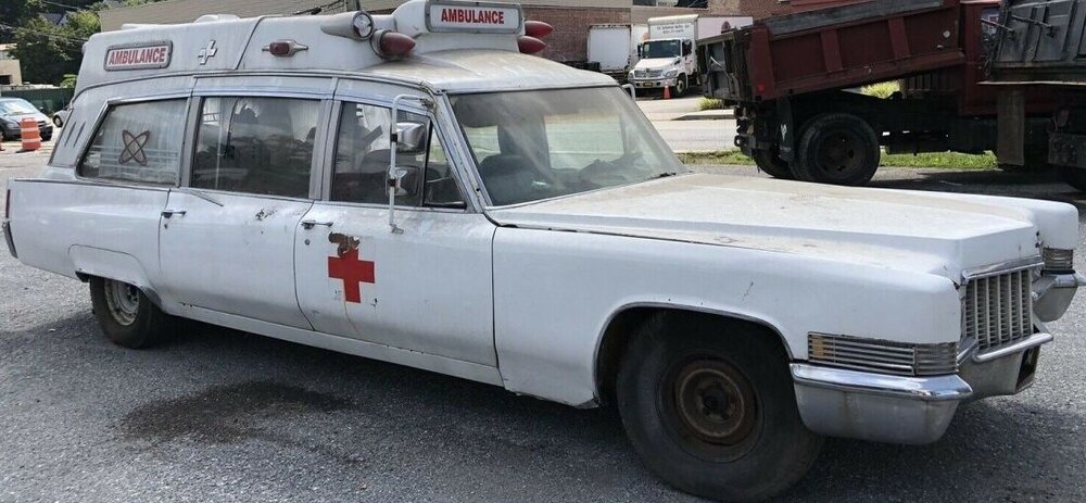 Could contain: vehicle, land vehicle, transport, wheel, outdoor, text, car, motor vehicle, vehicle registration plate, hardtop, tire, bumper, parked, ambulance, ground, white, truck