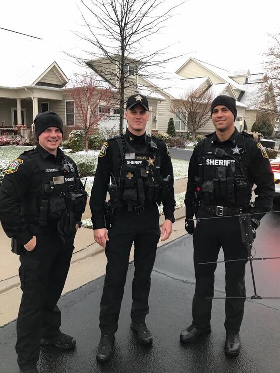 Could contain: person, man, outdoor, clothing, law enforcement, police officer, security, footwear, official, vehicle, government agency, uniform, land vehicle, organization, car, military rank, officer, military uniform, police