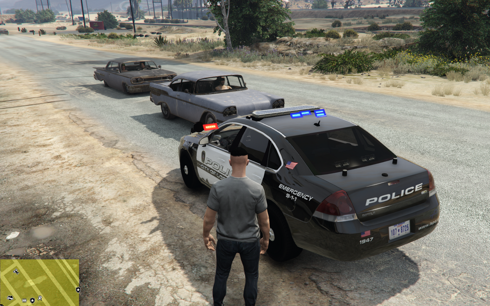 Could contain: outdoor, vehicle, text, land vehicle, wheel, tire, ground, vehicle registration plate, car, police, road, clothing, transport, person, man, street