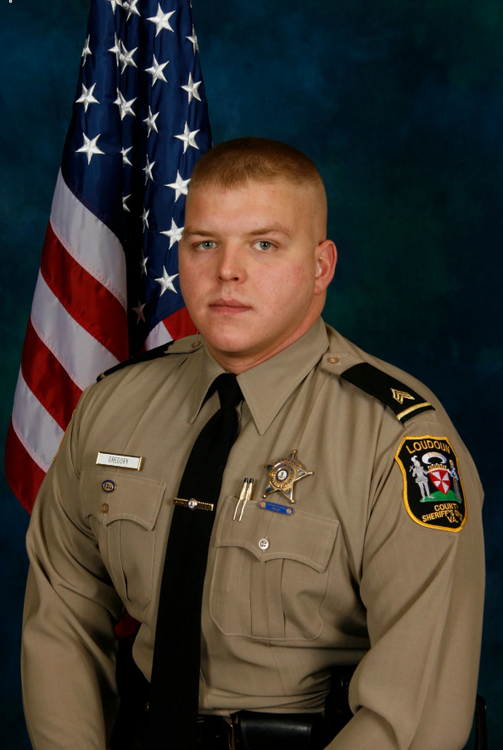 Could contain: person, clothing, military uniform, human face, official, military rank, government agency, organization, man, non-commissioned officer, law enforcement, military person, military officer, crew cut, uniform, flag, officer, military