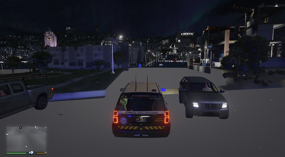 Could contain: vehicle, land vehicle, text, wheel, outdoor, night, light, car, city