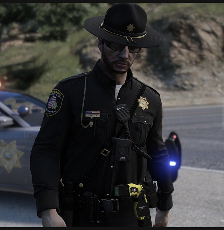 Could contain: clothing, person, outdoor, law enforcement, police officer, security, vehicle, man, car, land vehicle, police, official, officer