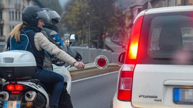 Could contain: vehicle, land vehicle, outdoor, car, wheel, vehicle registration plate, text, auto part, tire, automotive tail & brake light, road, person, automotive lighting, motorcycle, automotive exterior, clothing, motor vehicle, street, riding, police, helmet