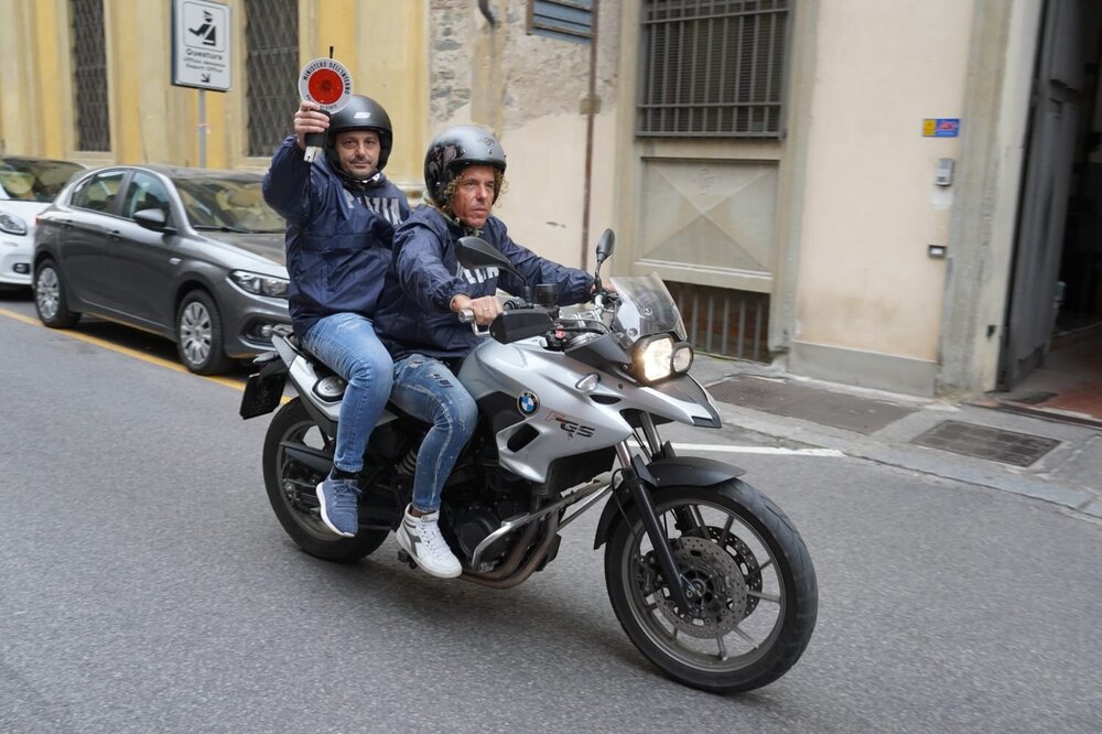Could contain: land vehicle, vehicle, wheel, tire, outdoor, clothing, person, motorbike, road, auto part, building, helmet, fender, motorcycle helmet, brake, street, motorcycle fairing, man, automotive tire, vehicle brake, cruiser, fuel tank, automotive exhaust, car, riding, rim, motorcycle, transport, motorcycling, sitting