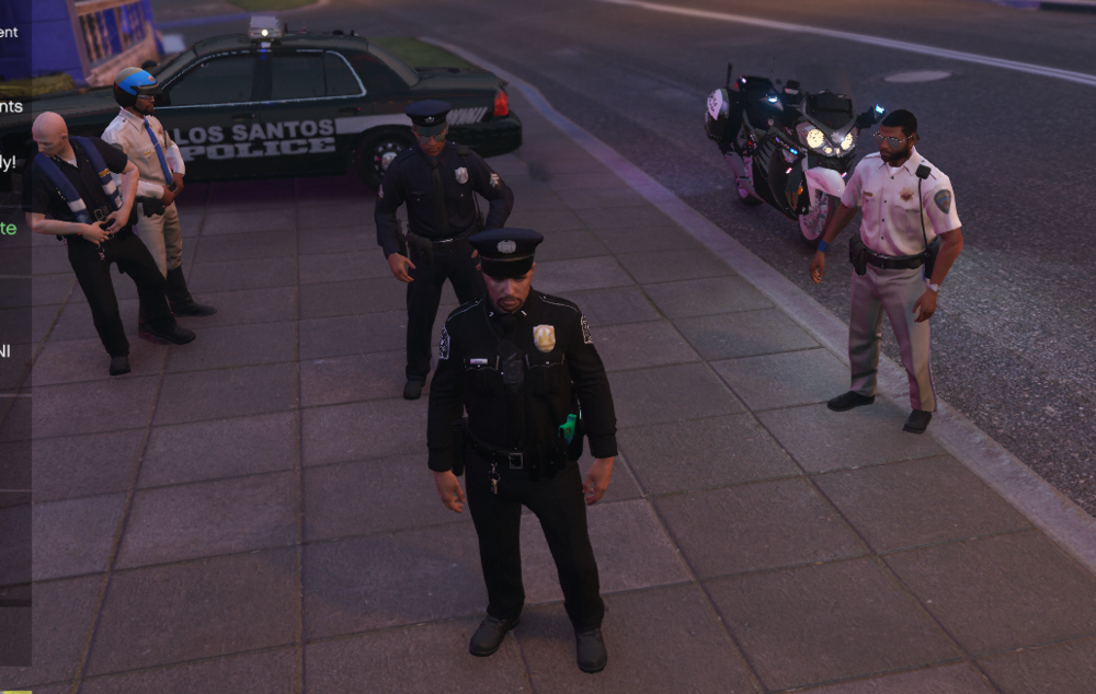 Could contain: clothing, vehicle, footwear, car, road, man, land vehicle, outdoor, person, law enforcement, pedestrian, street, police, people, officer, ground